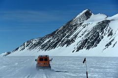 13A ALE Van Driving From Union Glacier Runway To Glacier Camp With Mount Rossmann On The Way To Climb Mount Vinson In Antarctica